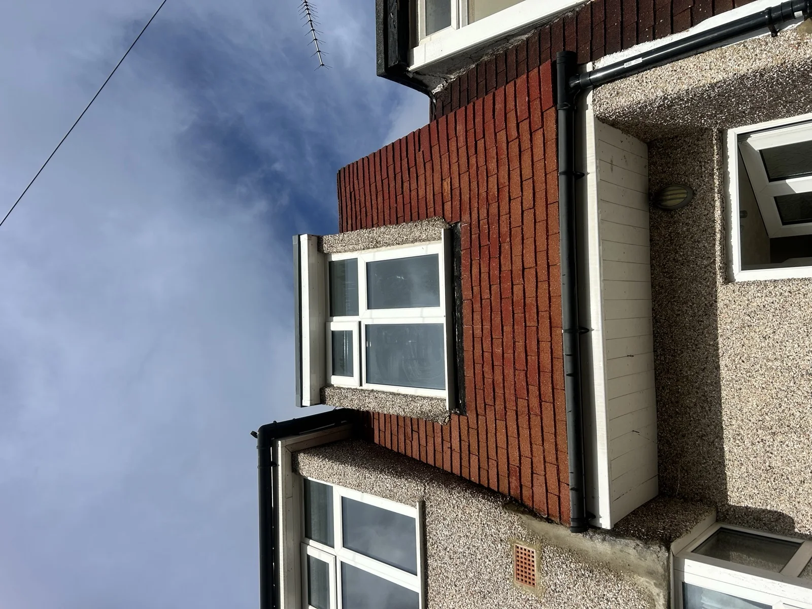 Roofline with gutter and downpipe on a Kent home